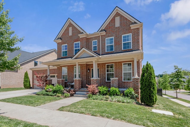 779 Newcomb St, Franklin, TN 37064 - view of front facade featuring brick siding, covered porch, a front lawn, and concrete driveway