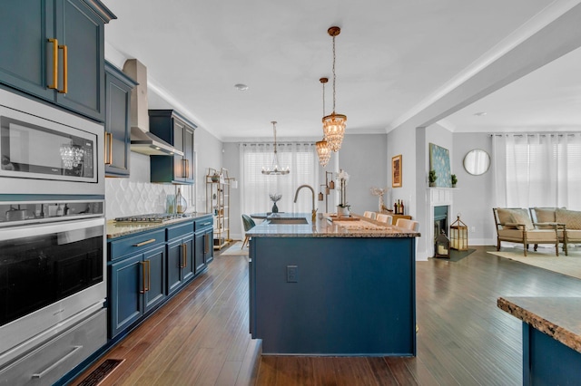 779 Newcomb St, Franklin, TN 37064 - kitchen featuring appliances with stainless steel finishes, a chandelier, blue cabinetry, a sink, and dark wood-style floors