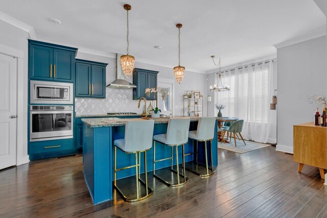 779 Newcomb St, Franklin, TN 37064 - kitchen with stainless steel appliances, blue cabinets, a chandelier, a breakfast bar, and backsplash