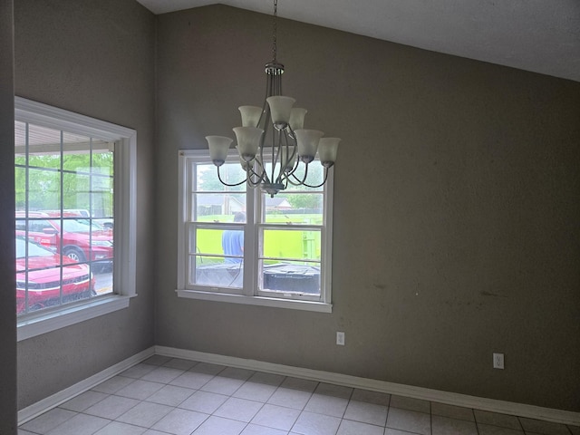 unfurnished dining area featuring vaulted ceiling, light tile patterned flooring, an inviting chandelier, and plenty of natural light