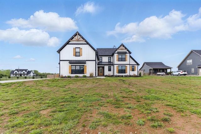 modern inspired farmhouse with fence, board and batten siding, and a front yard