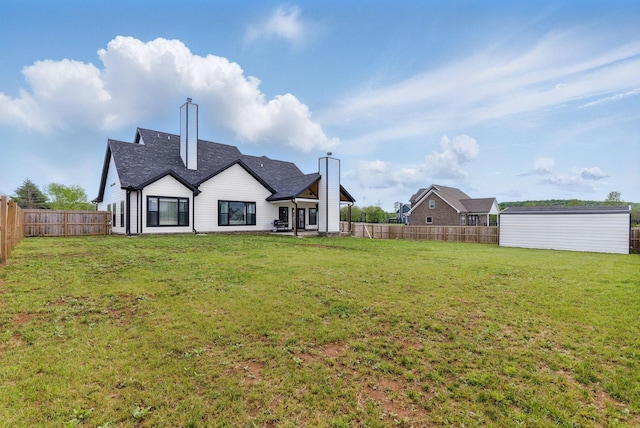 back of house with a chimney, a fenced backyard, a patio area, and a lawn