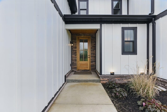 view of exterior entry featuring board and batten siding