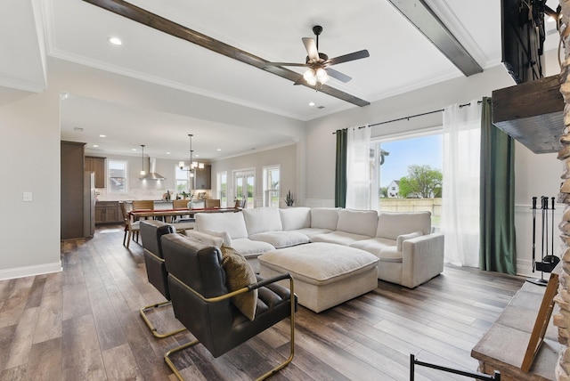 living room with recessed lighting, hardwood / wood-style floors, beam ceiling, and ceiling fan with notable chandelier