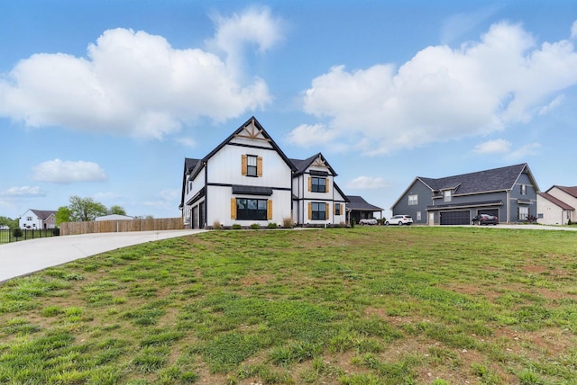 view of front of home with a front lawn, driveway, and fence