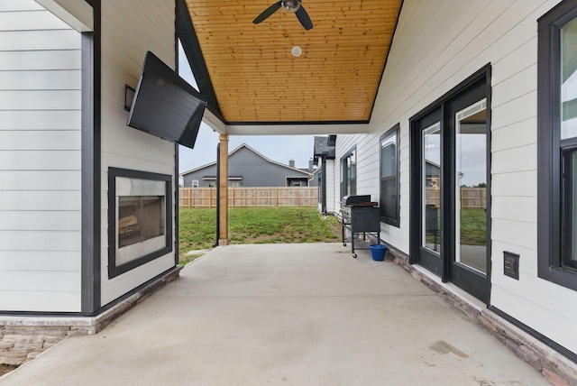view of patio with fence and ceiling fan