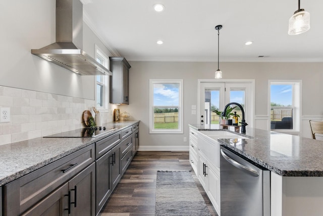 kitchen featuring wall chimney range hood, black electric stovetop, a sink, dishwasher, and dark wood-type flooring