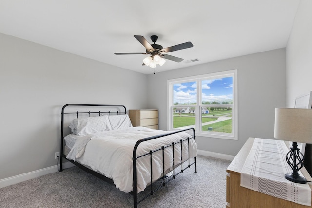 bedroom featuring visible vents, light carpet, a ceiling fan, and baseboards