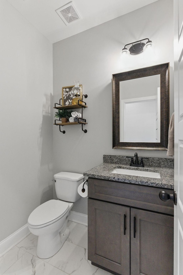 bathroom with visible vents, vanity, marble finish floor, and baseboards