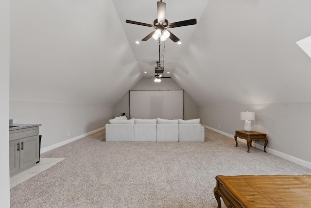 additional living space featuring ceiling fan, vaulted ceiling, light colored carpet, and baseboards