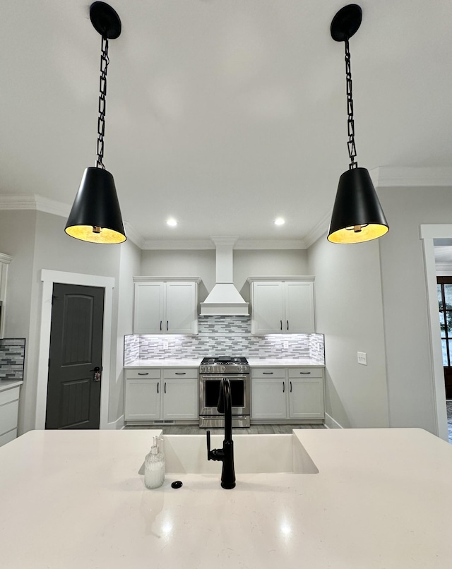 1049 Veridian Dr Unit A, Clarksville, TN 37043 - kitchen featuring premium range hood, stainless steel range with gas cooktop, decorative backsplash, decorative light fixtures, and crown molding