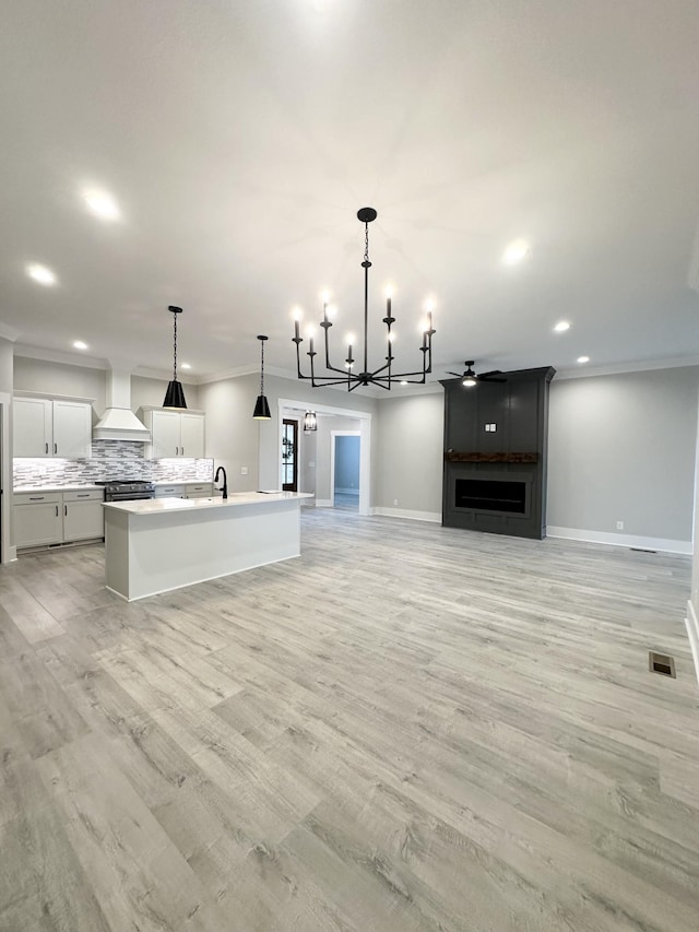 1049 Veridian Dr Unit A, Clarksville, TN 37043 - unfurnished living room featuring a chandelier, baseboards, recessed lighting, light wood-style flooring, and a sink