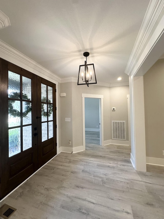 1049 Veridian Dr Unit A, Clarksville, TN 37043 - foyer entrance with french doors, a chandelier, light wood-style flooring, crown molding, and baseboards