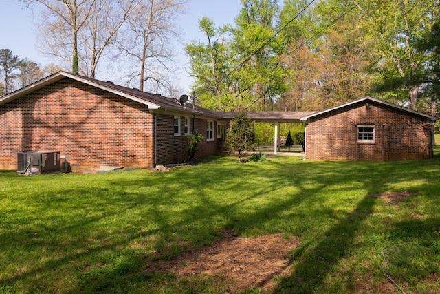 1203 W White Oak Dr, Cookeville, TN 38501 - back of house with brick siding, a lawn, and central air condition unit