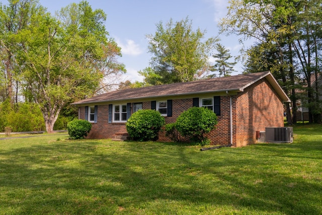 1203 W White Oak Dr, Cookeville, TN 38501 - view of front of house featuring central air condition unit, a front yard, and brick siding