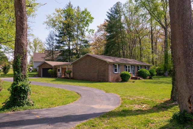 1203 W White Oak Dr, Cookeville, TN 38501 - ranch-style home featuring curved driveway, a garage, a front lawn, and brick siding