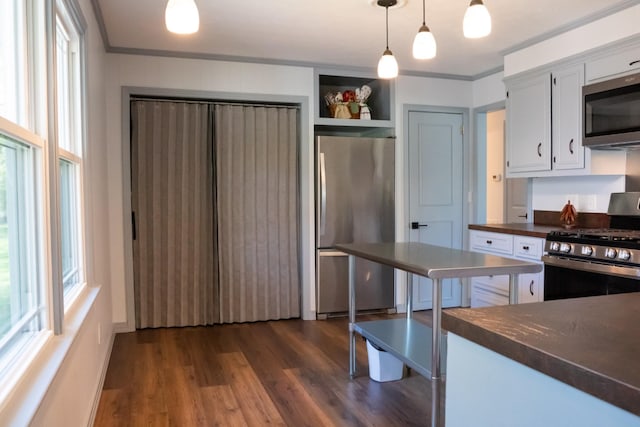1203 W White Oak Dr, Cookeville, TN 38501 - kitchen with decorative light fixtures, dark wood-style floors, crown molding, white cabinetry, and stainless steel appliances