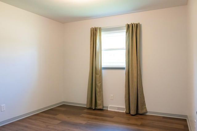 1203 W White Oak Dr, Cookeville, TN 38501 - spare room featuring visible vents, dark wood-style flooring, and baseboards