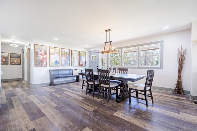 dining space with a chandelier, recessed lighting, baseboards, and wood finished floors