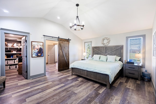 bedroom with wood finished floors, an inviting chandelier, recessed lighting, and a barn door