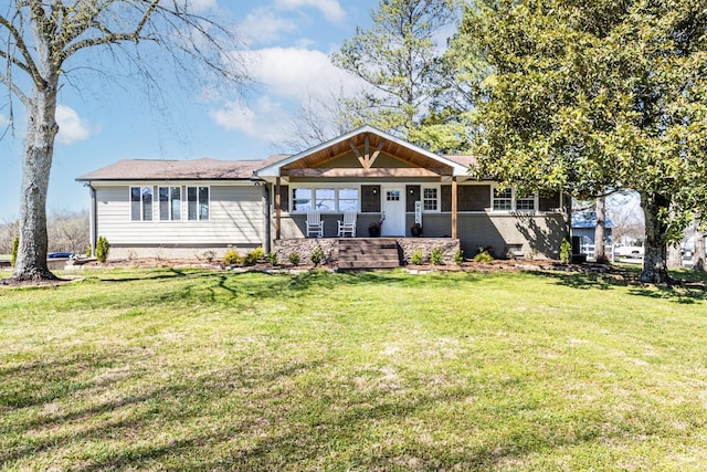 view of front facade with covered porch and a front yard