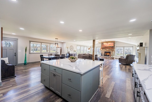 kitchen featuring gray cabinets, a center island, dark wood-style flooring, and a wealth of natural light