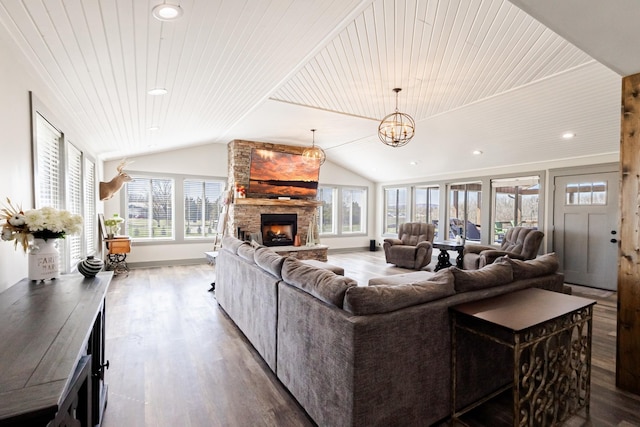 living area with a stone fireplace, recessed lighting, a chandelier, wood finished floors, and lofted ceiling