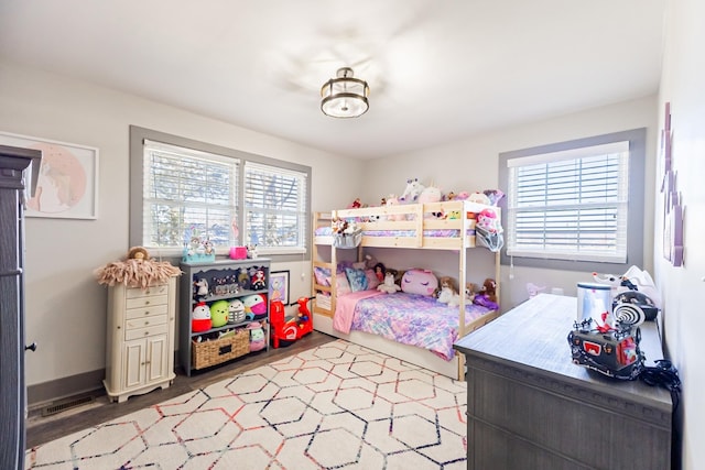 bedroom with visible vents and wood finished floors