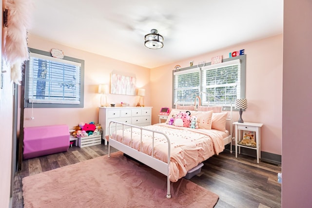 bedroom with dark wood-type flooring