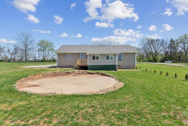 rear view of house featuring a patio, a shingled roof, crawl space, and a lawn