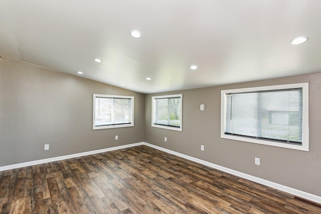 empty room with recessed lighting, dark wood-style flooring, and baseboards