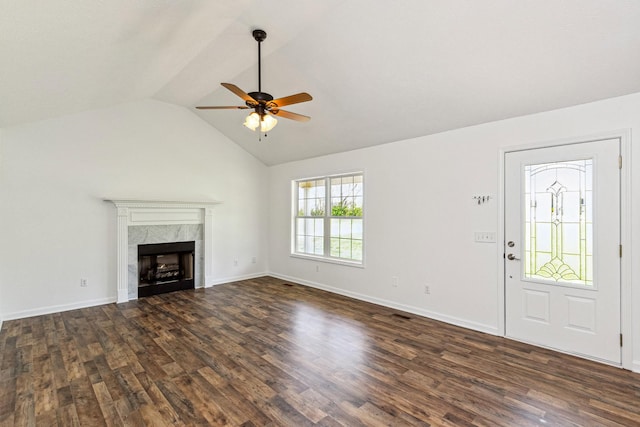 unfurnished living room featuring dark wood-style flooring, ceiling fan, vaulted ceiling, and a fireplace