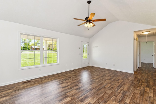 unfurnished room with visible vents, ceiling fan, dark wood finished floors, attic access, and vaulted ceiling