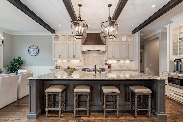 700 Pendragon Ct, Franklin, TN 37067 - kitchen featuring an inviting chandelier, beamed ceiling, tasteful backsplash, a large island, and premium range hood