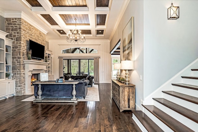 700 Pendragon Ct, Franklin, TN 37067 - living room featuring an inviting chandelier, a fireplace, crown molding, beamed ceiling, and wood finished floors
