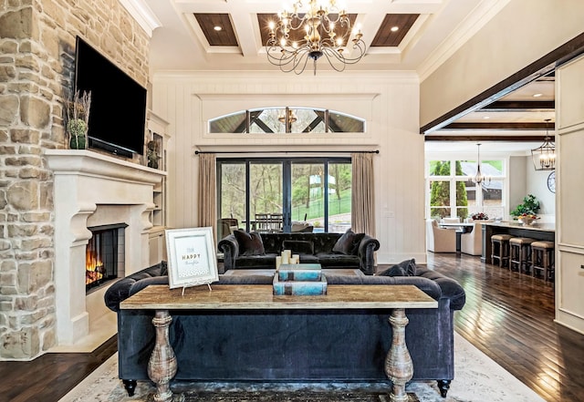 700 Pendragon Ct, Franklin, TN 37067 - living room featuring an inviting chandelier, ornamental molding, a stone fireplace, and hardwood / wood-style flooring