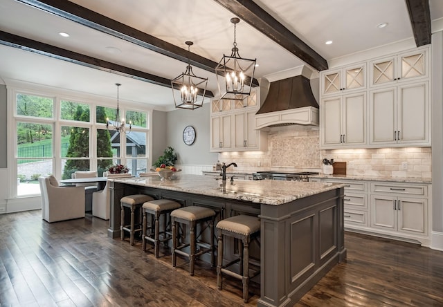 700 Pendragon Ct, Franklin, TN 37067 - kitchen with custom range hood, light stone countertops, a notable chandelier, and a healthy amount of sunlight
