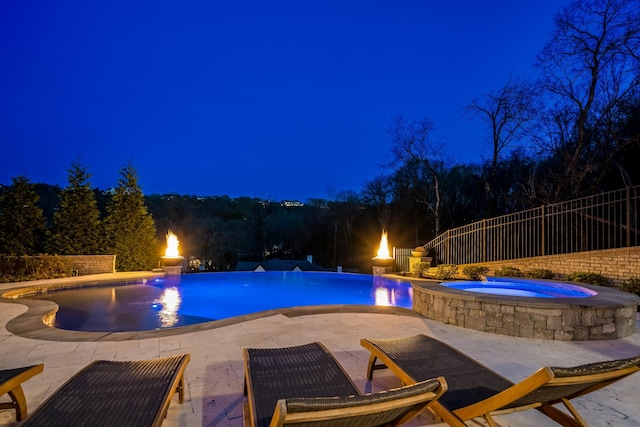 700 Pendragon Ct, Franklin, TN 37067 - pool at night featuring a fenced in pool, a patio, an in ground hot tub, and fence