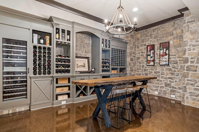700 Pendragon Ct, Franklin, TN 37067 - wine room with finished concrete flooring, a notable chandelier, beverage cooler, and bar