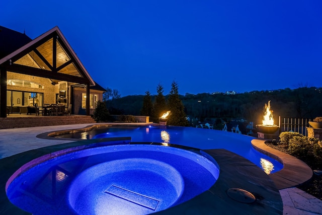 700 Pendragon Ct, Franklin, TN 37067 - pool at twilight with a patio area, an infinity pool, and an in ground hot tub