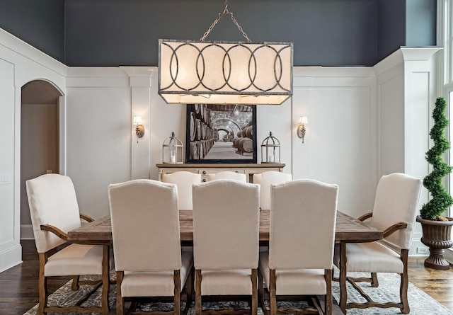 700 Pendragon Ct, Franklin, TN 37067 - dining area with arched walkways, dark wood-type flooring, and a decorative wall