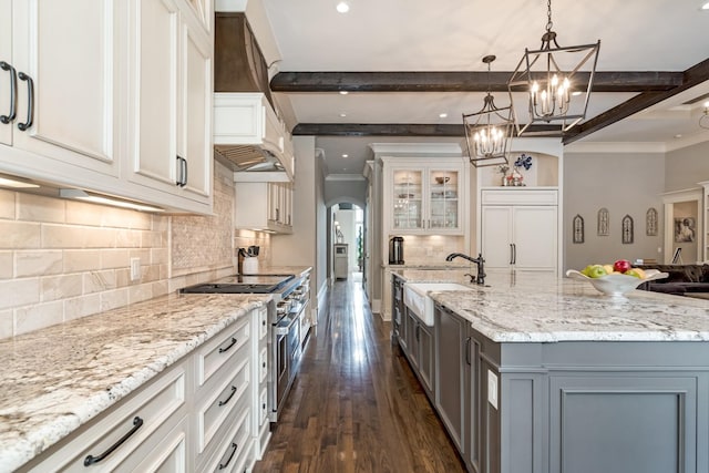 700 Pendragon Ct, Franklin, TN 37067 - kitchen with ornamental molding, a chandelier, beam ceiling, premium appliances, and arched walkways