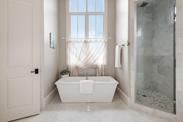 700 Pendragon Ct, Franklin, TN 37067 - bathroom featuring tiled shower, baseboards, and a freestanding tub