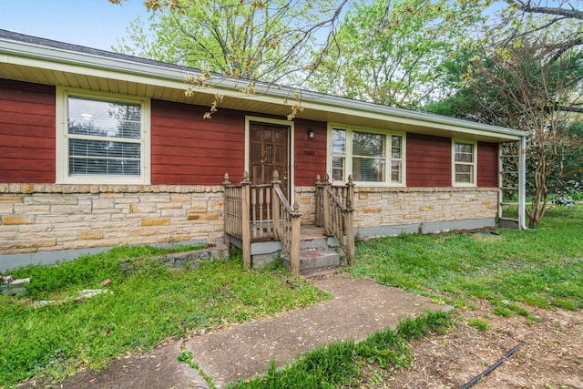 ranch-style home with stone siding