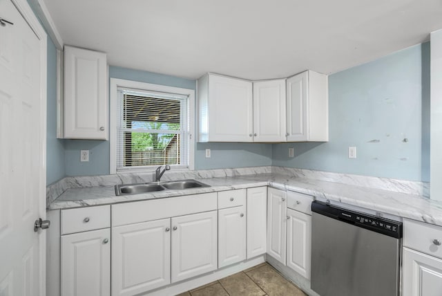 kitchen with stainless steel dishwasher, a sink, white cabinets, and light tile patterned flooring