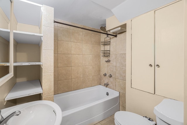 bathroom featuring toilet, tile patterned floors, a sink, and shower / bathtub combination