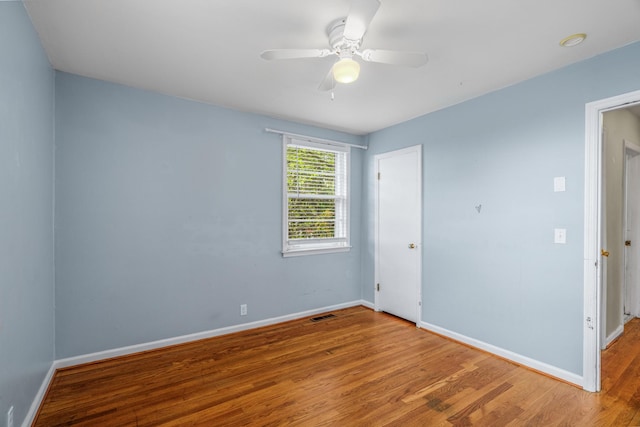 unfurnished bedroom with wood finished floors, baseboards, and ceiling fan