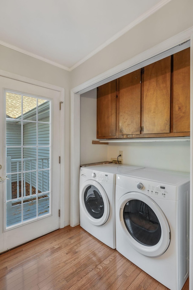 125 Sunnyside Ln, Columbia, TN 38401 - clothes washing area featuring washing machine and clothes dryer, cabinet space, crown molding, and light wood-style flooring