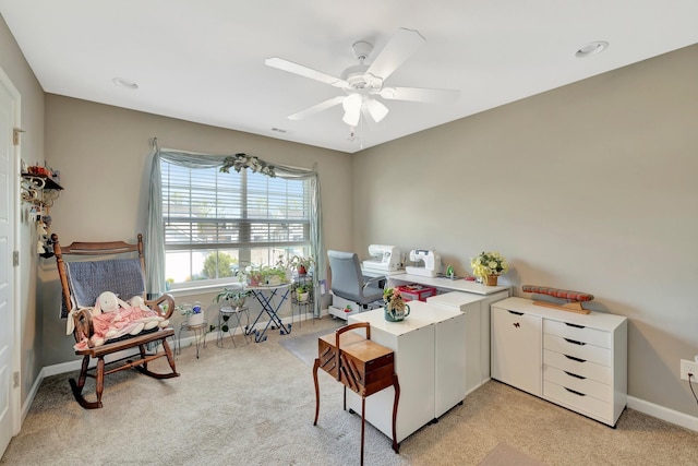 office area with visible vents, ceiling fan, light carpet, and baseboards