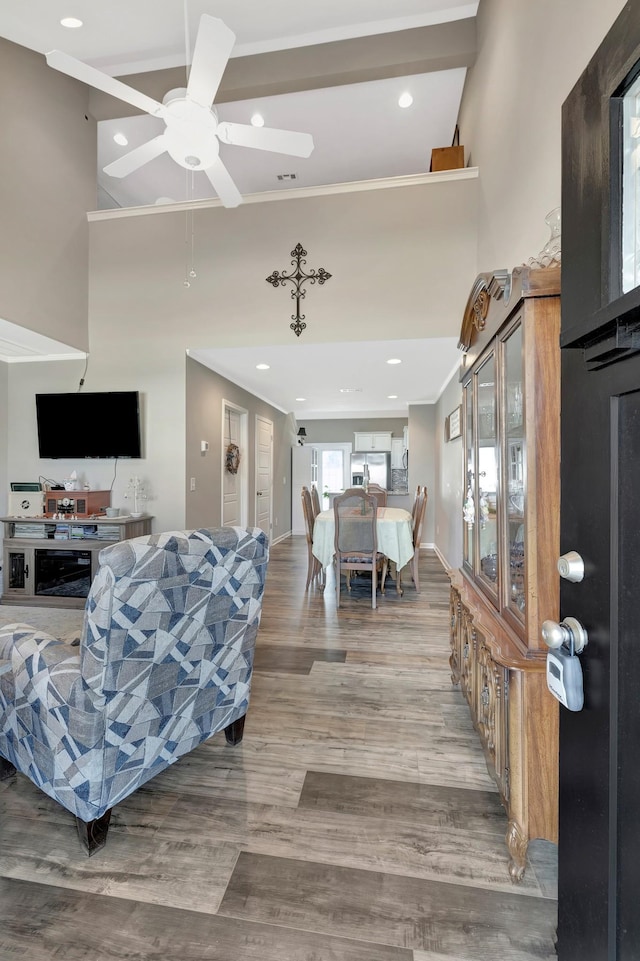 living room with recessed lighting, ornamental molding, and a ceiling fan